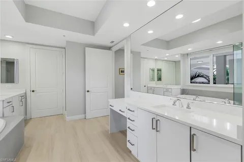 a spacious bathroom with a double vanity sink mirror and
