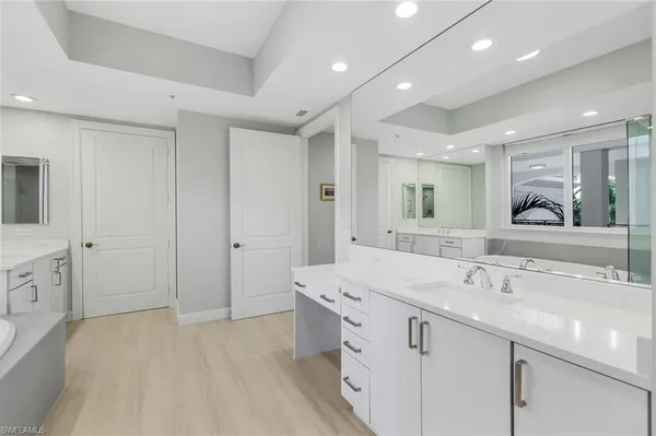 a spacious bathroom with a double vanity sink mirror and
