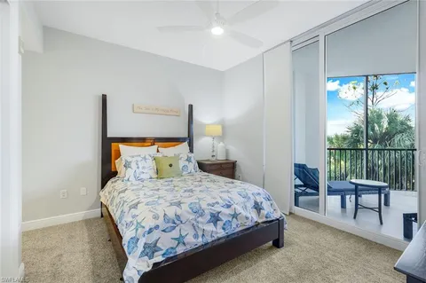 a bedroom with a bed and a lamp next to a window