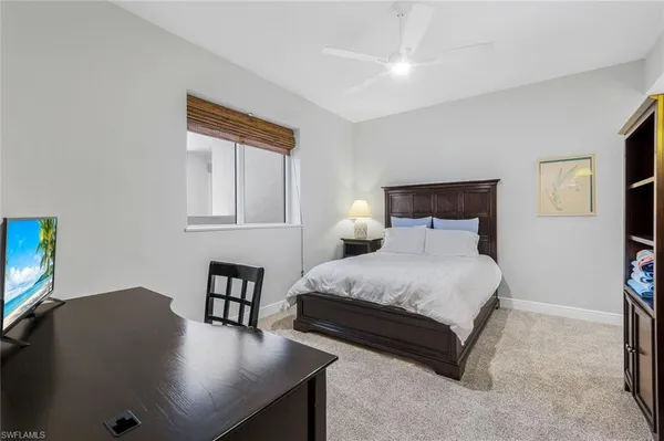 a bedroom with a bed and a desk