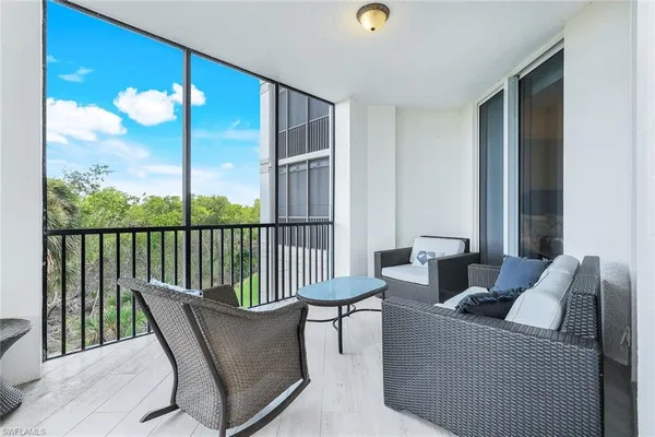 a balcony with furniture and a potted plant