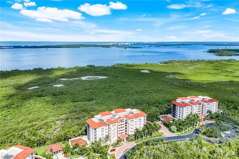 a front view of a residential apartment building with a yard