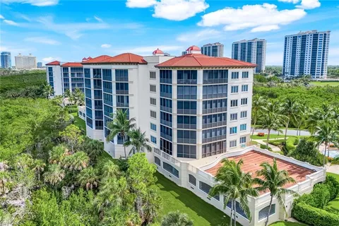 a view of a city and a lot of trees & fence