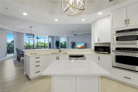 a kitchen with white cabinets and appliances