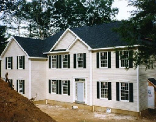Lot24 Lake Ridge Road Southbury, CT 06488 - Photo 1 of 1 a view of a white house with large windows and a small yard