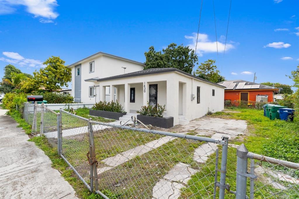 1430 Northwest 74th Street Miami, FL 33147 - Photo 1 of 29 a view of a house with backyard and sitting area