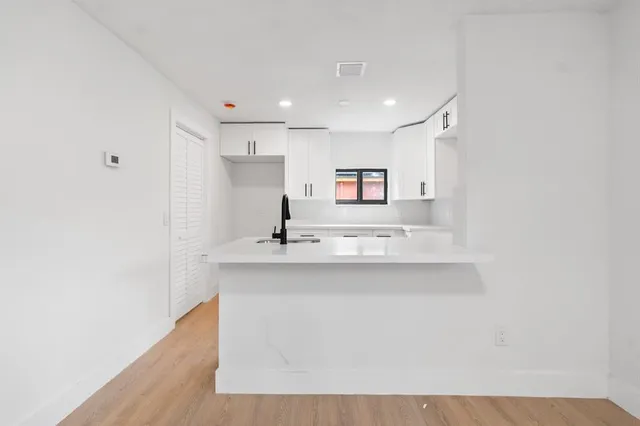 a kitchen with stainless steel appliances a sink and a refrigerator
