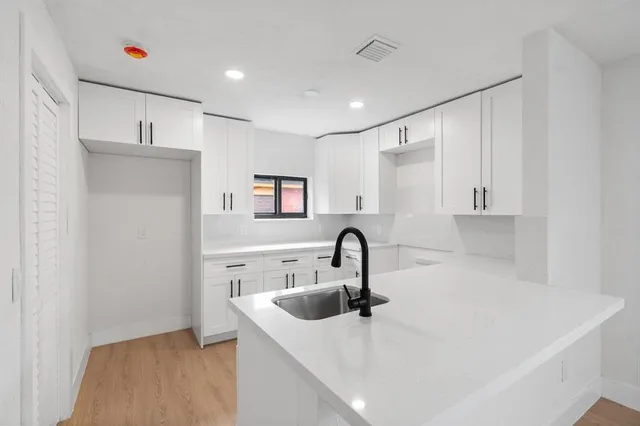 a kitchen with a refrigerator and a sink