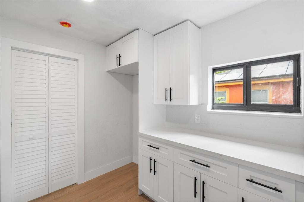 1430 Northwest 74th Street Miami, FL 33147 - Photo 15 of 29 a hallway with cabinets