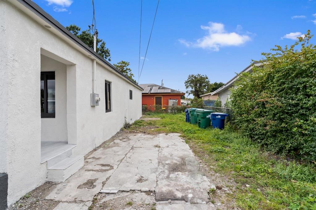 1430 Northwest 74th Street Miami, FL 33147 - Photo 4 of 29 a front view of a house with a yard