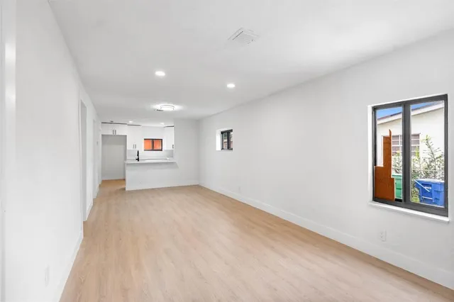 a view of a big room with windows and cabinet