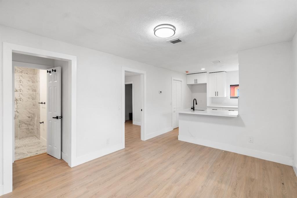 1430 Northwest 74th Street Miami, FL 33147 - Photo 8 of 29 a view of kitchen with wooden floor