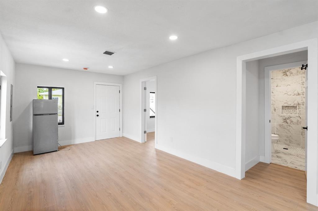 1430 Northwest 74th Street Miami, FL 33147 - Photo 9 of 29 wooden floor in an empty room with wooden floor