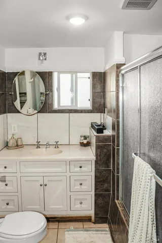 a bathroom with a granite countertop sink a toilet and vanity
