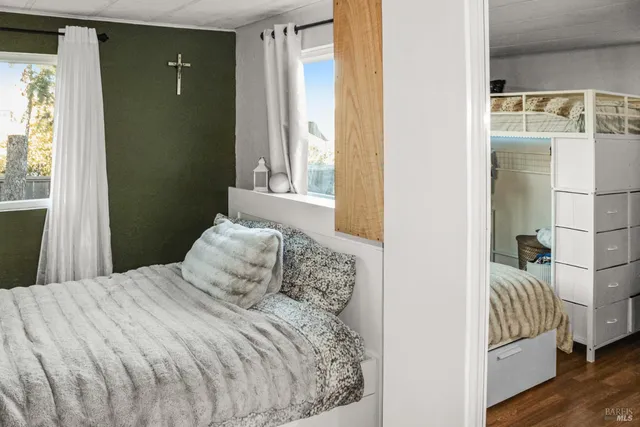 a bedroom with a bed and a window