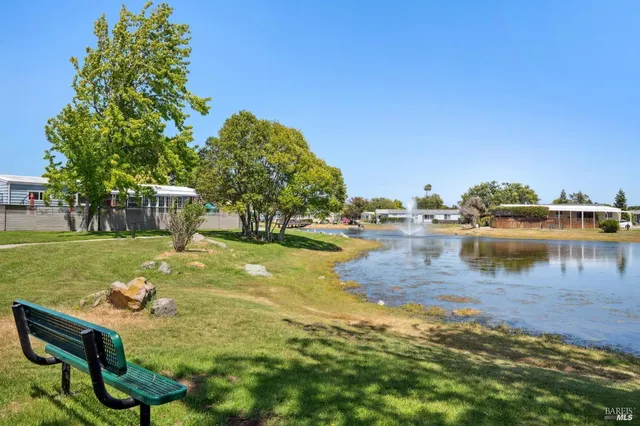 a view of a lake with houses in the back