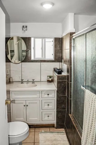a bathroom with a double vanity sink and mirror