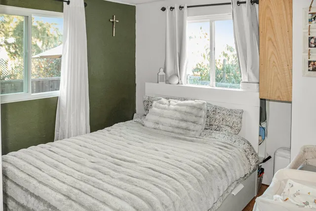 a bedroom with a bed and a window