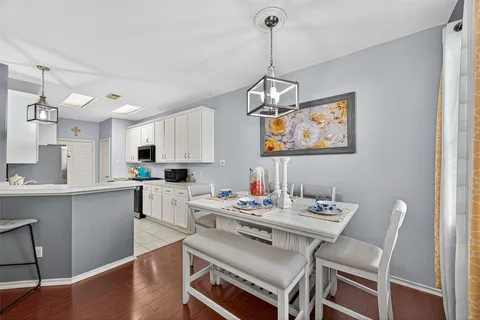 a kitchen with white cabinets and appliances