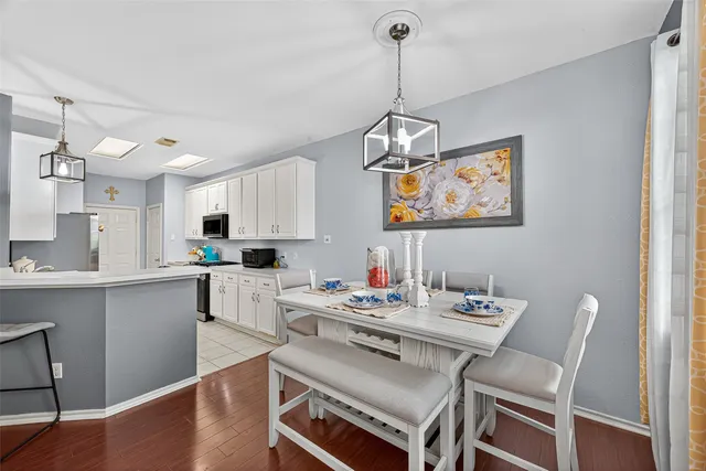 a kitchen with white cabinets and appliances