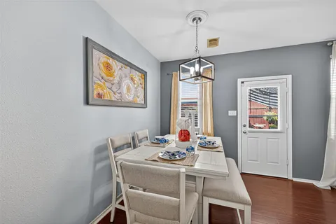 a living room with stainless steel appliances kitchen island granite countertop furniture and wooden floor