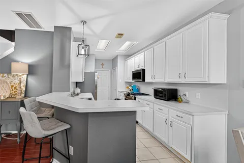 a kitchen with a sink appliances and cabinets