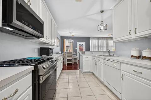 a kitchen with a refrigerator sink and cabinets
