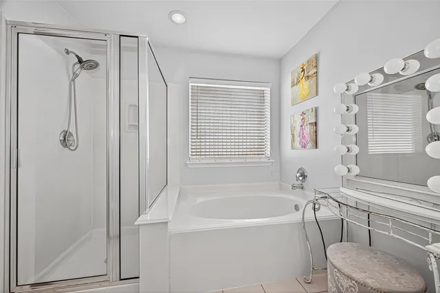 a bathroom with a bathtub and a shower