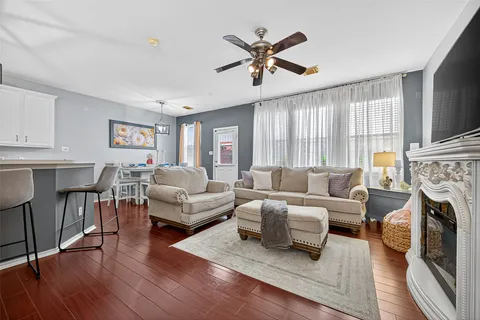 a living room with furniture a fireplace and a flat screen tv