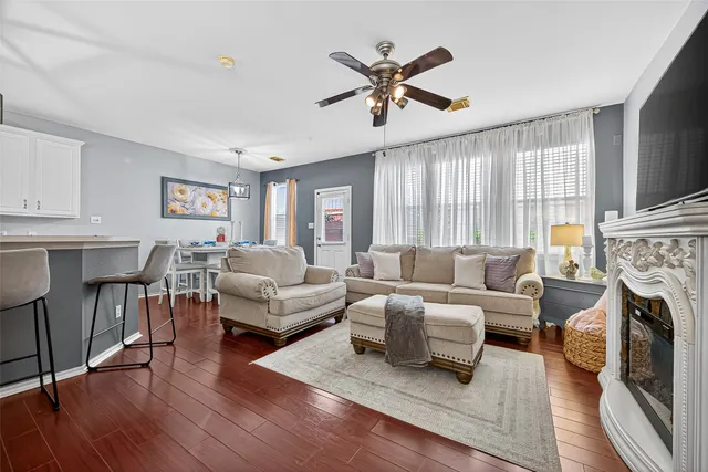 a living room with furniture a fireplace and a flat screen tv