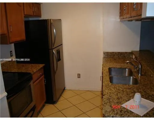 a kitchen with a refrigerator and a stove