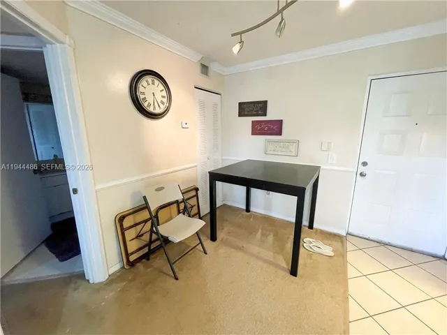 a view of a hallway with front door and wooden floor