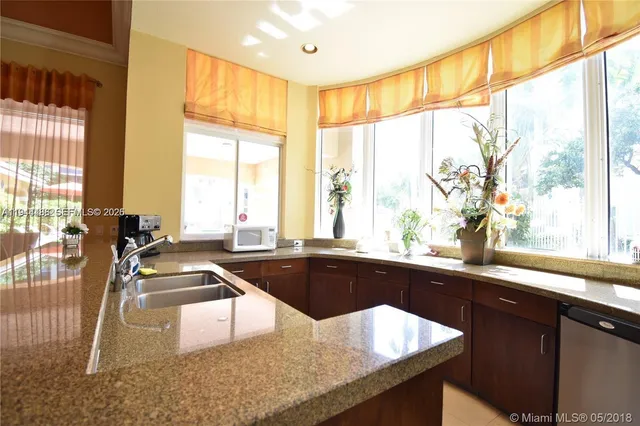a kitchen with granite countertop a sink and a window