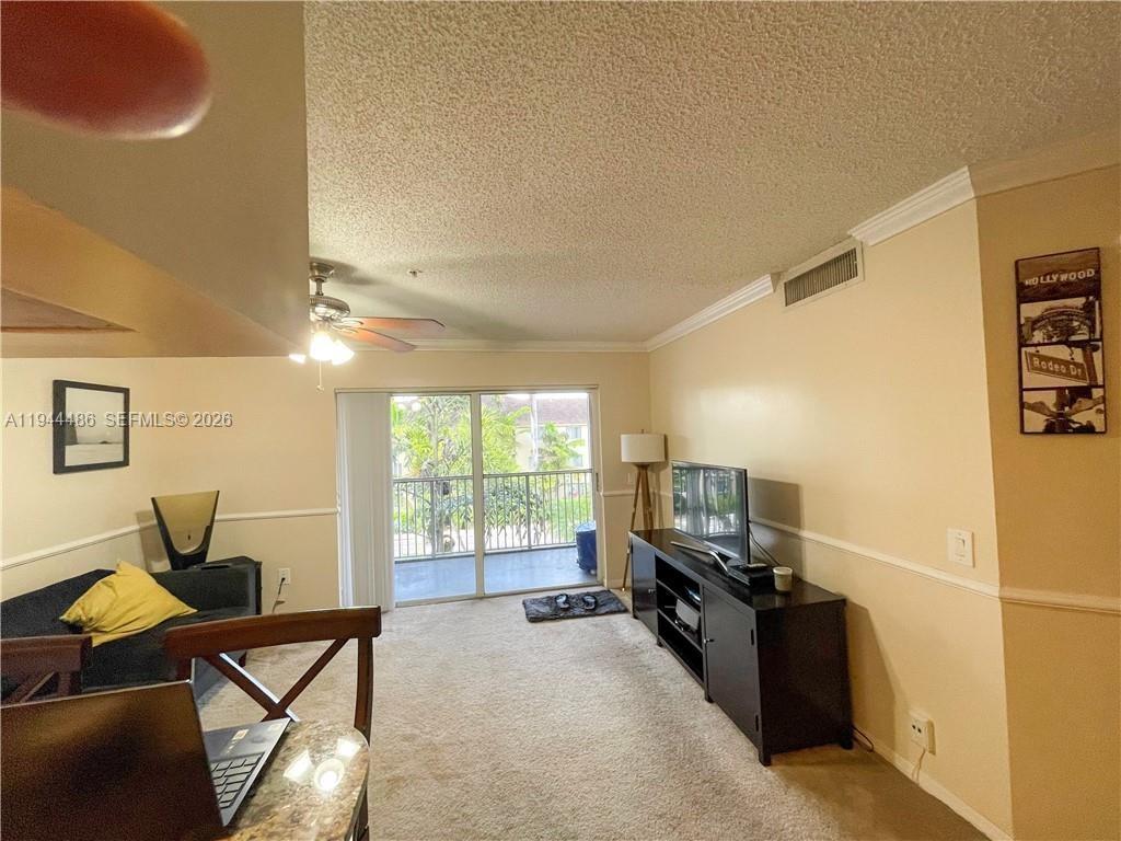 470 South Park Road, Unit 7306 Hollywood, FL 33021 - Photo 3 of 20 a living room with furniture and a flat screen tv