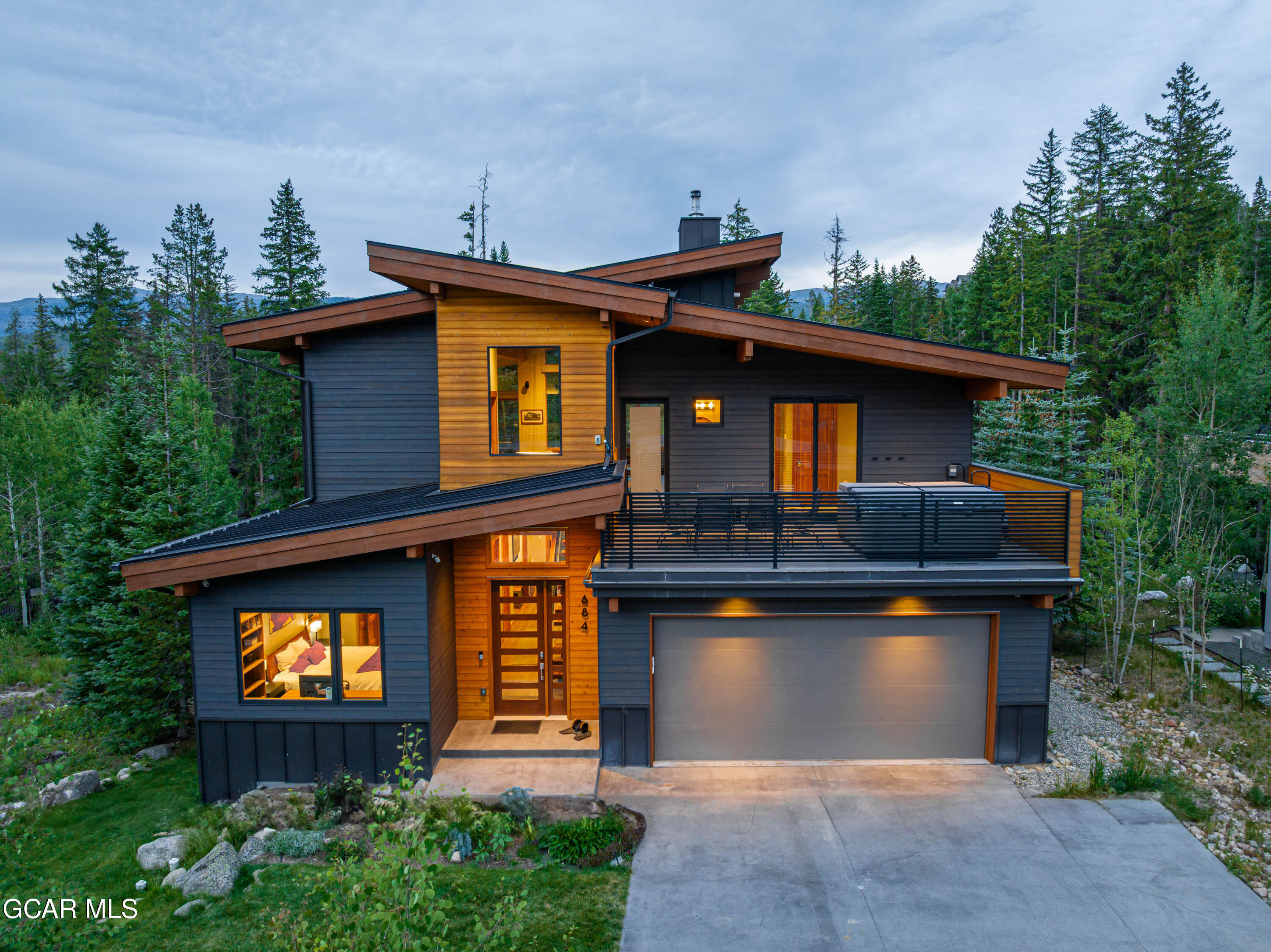 684 Vasquez Road Winter Park, CO 80482 - Photo 2 of 45 a front view of a house with garden