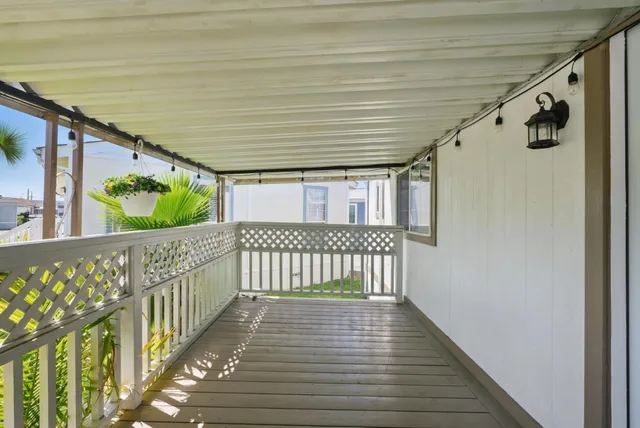a view of a porch with wooden floor