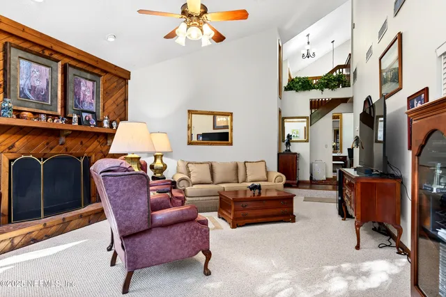 a view of a house with a big yard and large trees