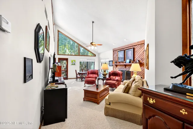a bedroom with a bed large window with table and chairs
