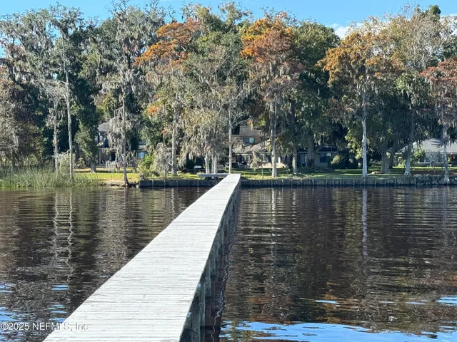 a view of a patio with table and chairs and wooden floor