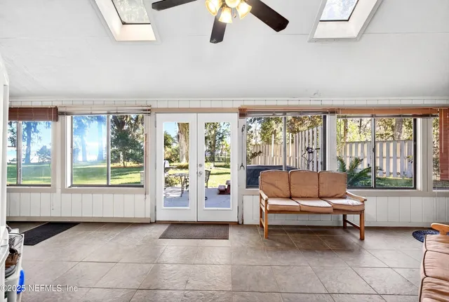 a living room with furniture a window and a flat screen tv