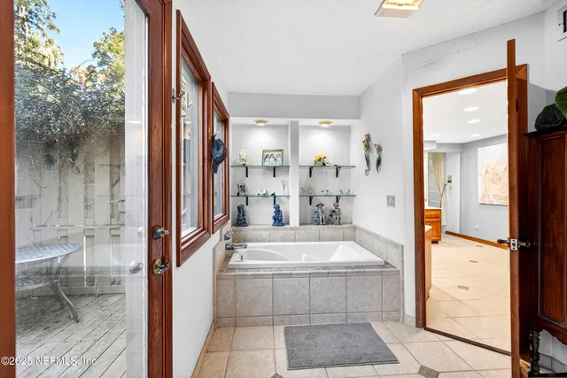 a living room with furniture and a book shelf