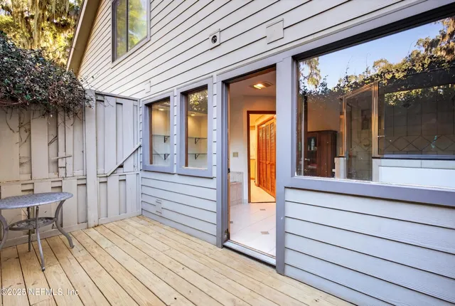a living room with furniture and a book shelf