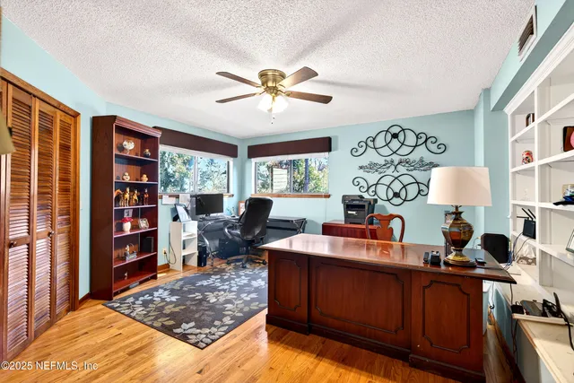 a view of a swimming pool with a patio and a yard