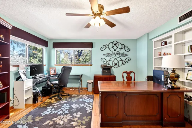 a view of an entryway with wooden floor and livingroom view