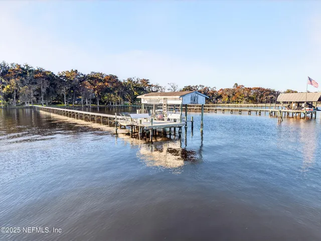 a living room with furniture a window and a flat screen tv