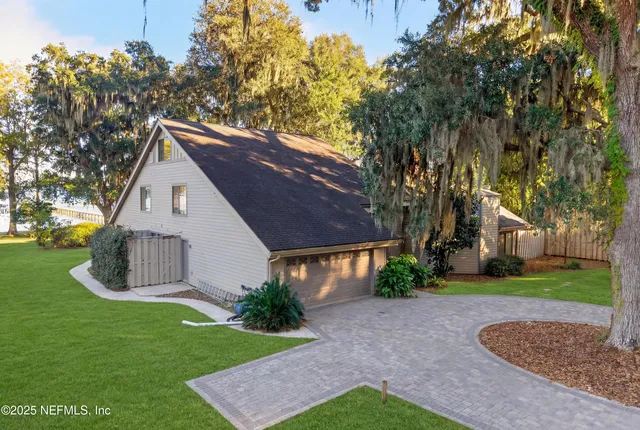 a kitchen with a stove a sink and a dining table view