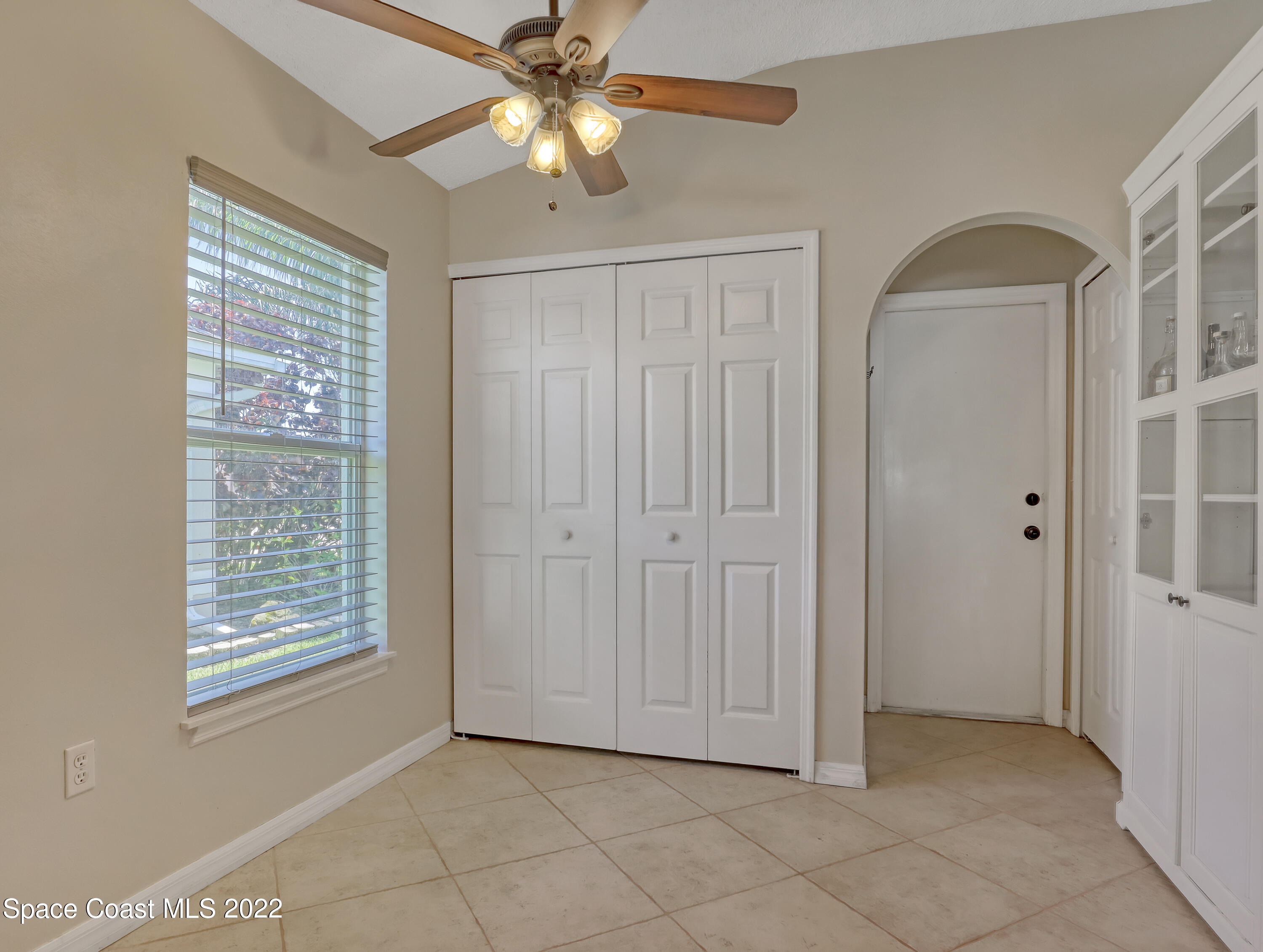 4920 Spinet Drive Melbourne, FL 32940 - Photo 11 of 44 an empty room with windows and fan