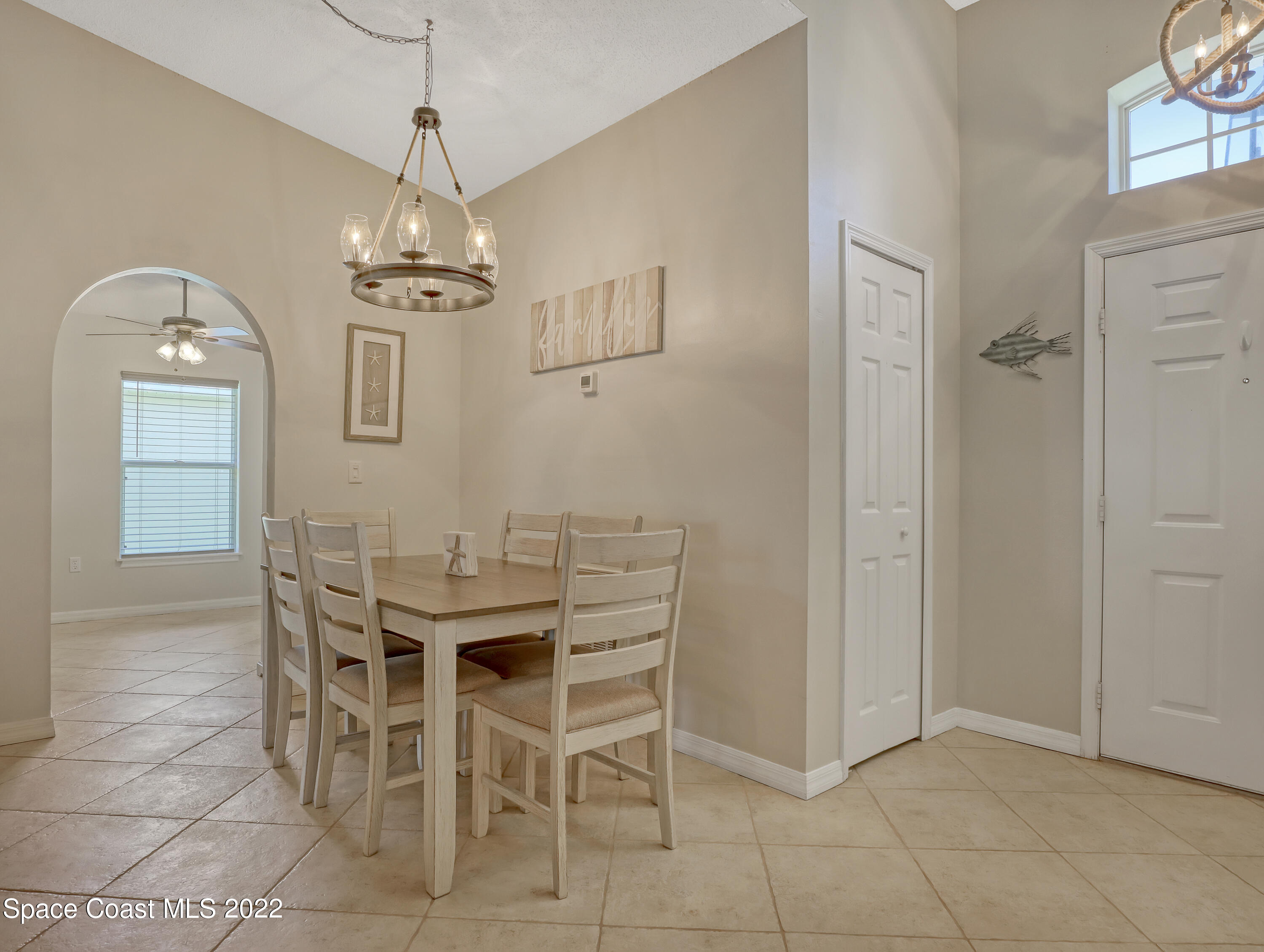 4920 Spinet Drive Melbourne, FL 32940 - Photo 12 of 44 a view of a dining room with furniture and chandelier