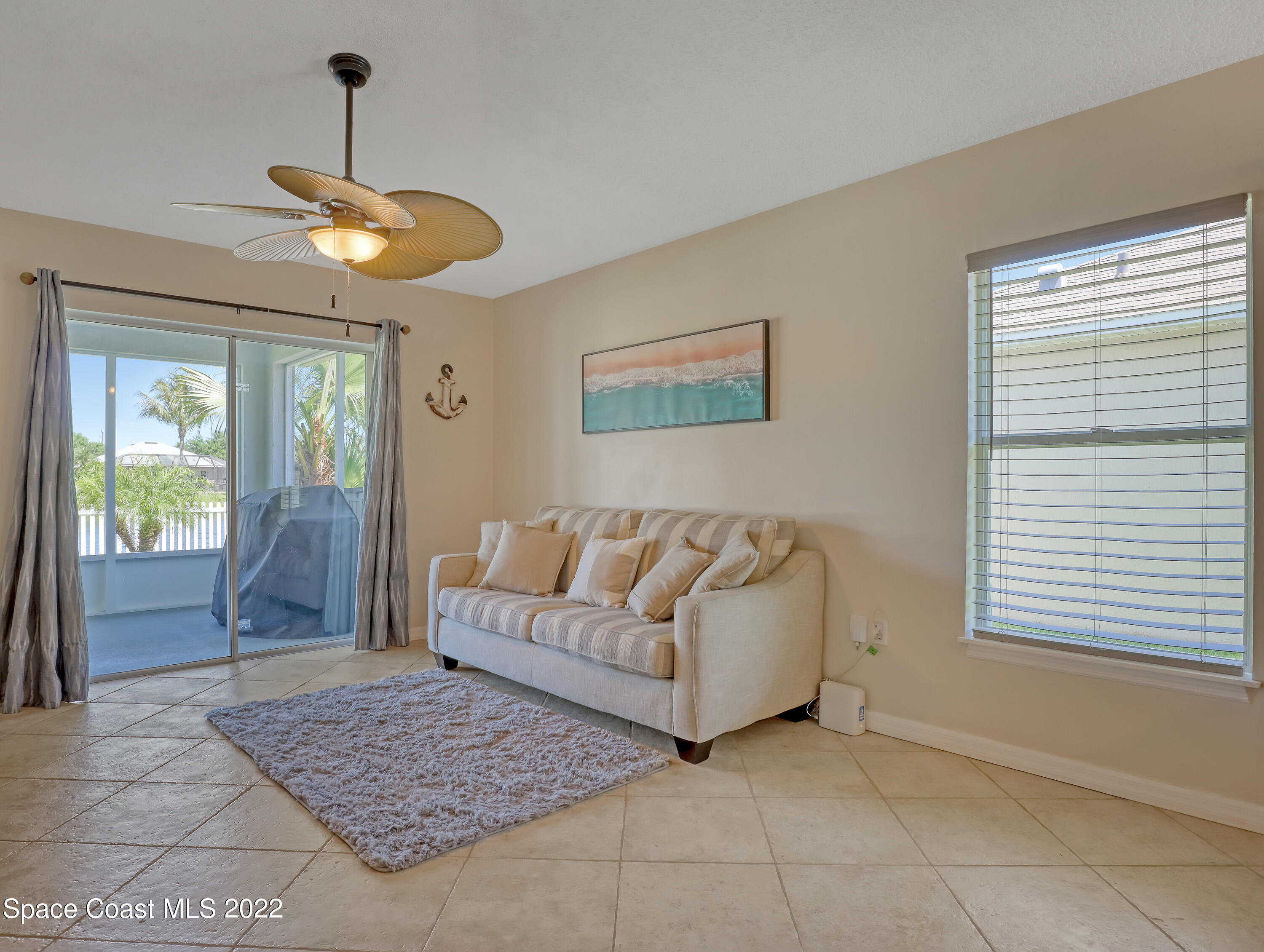 4920 Spinet Drive Melbourne, FL 32940 - Photo 15 of 44 a living room with furniture and a chandelier