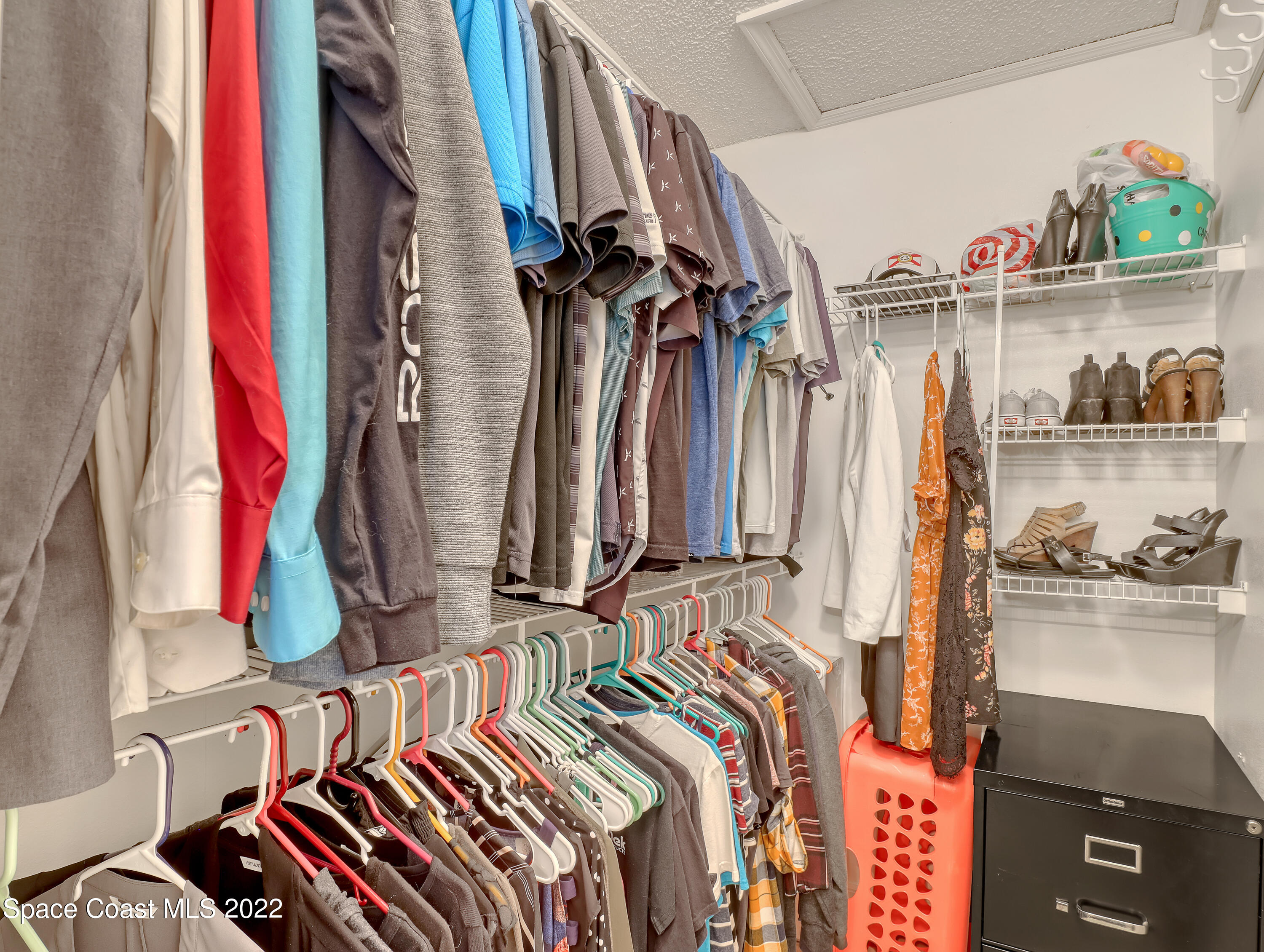 4920 Spinet Drive Melbourne, FL 32940 - Photo 21 of 44 a view of walk in closet with clothes and shoes